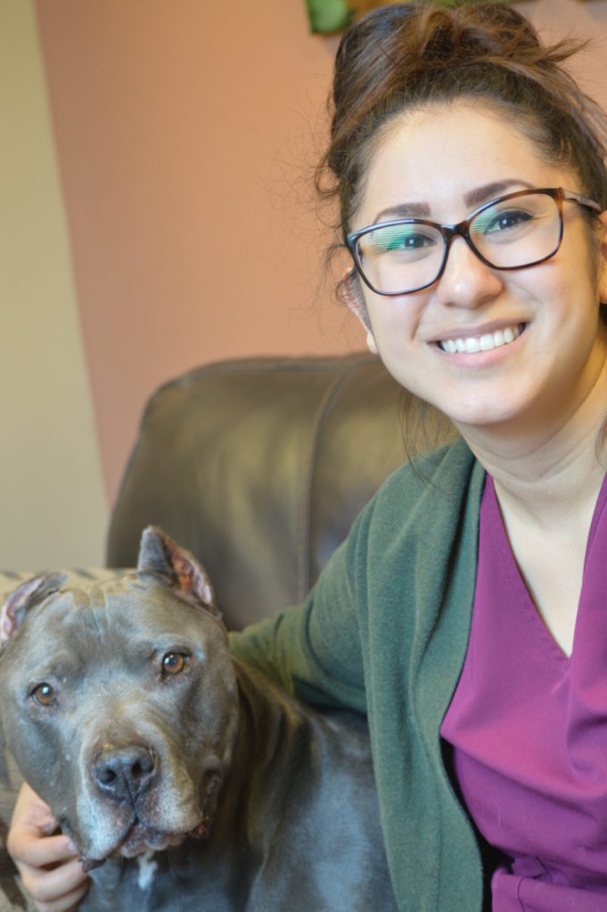 young woman with brown pitbull